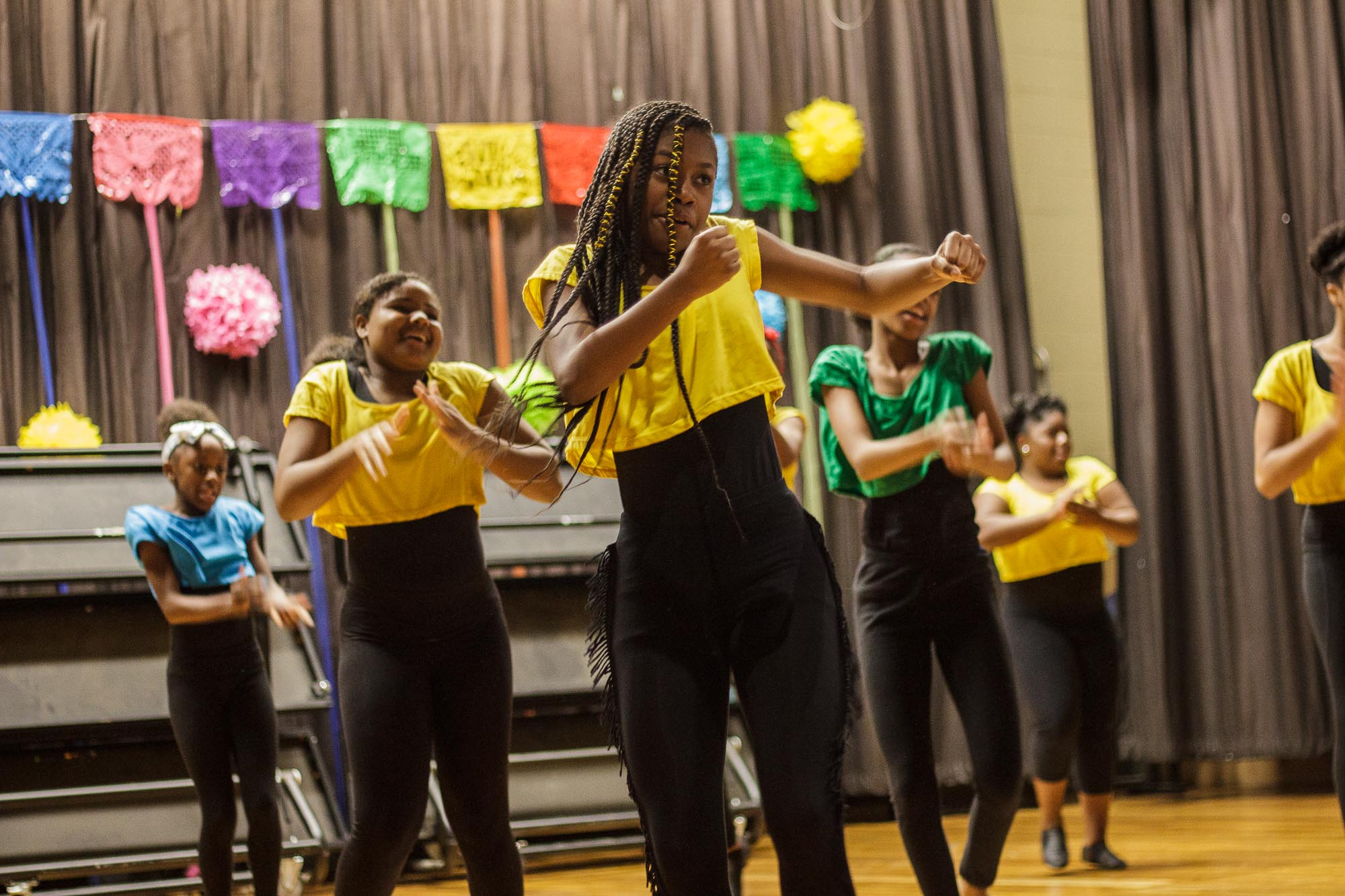 Members of the Colonia Middle School’s dance ensemble put on a pop-up performance of Latin American dance for students and guests. (Renier Otto)