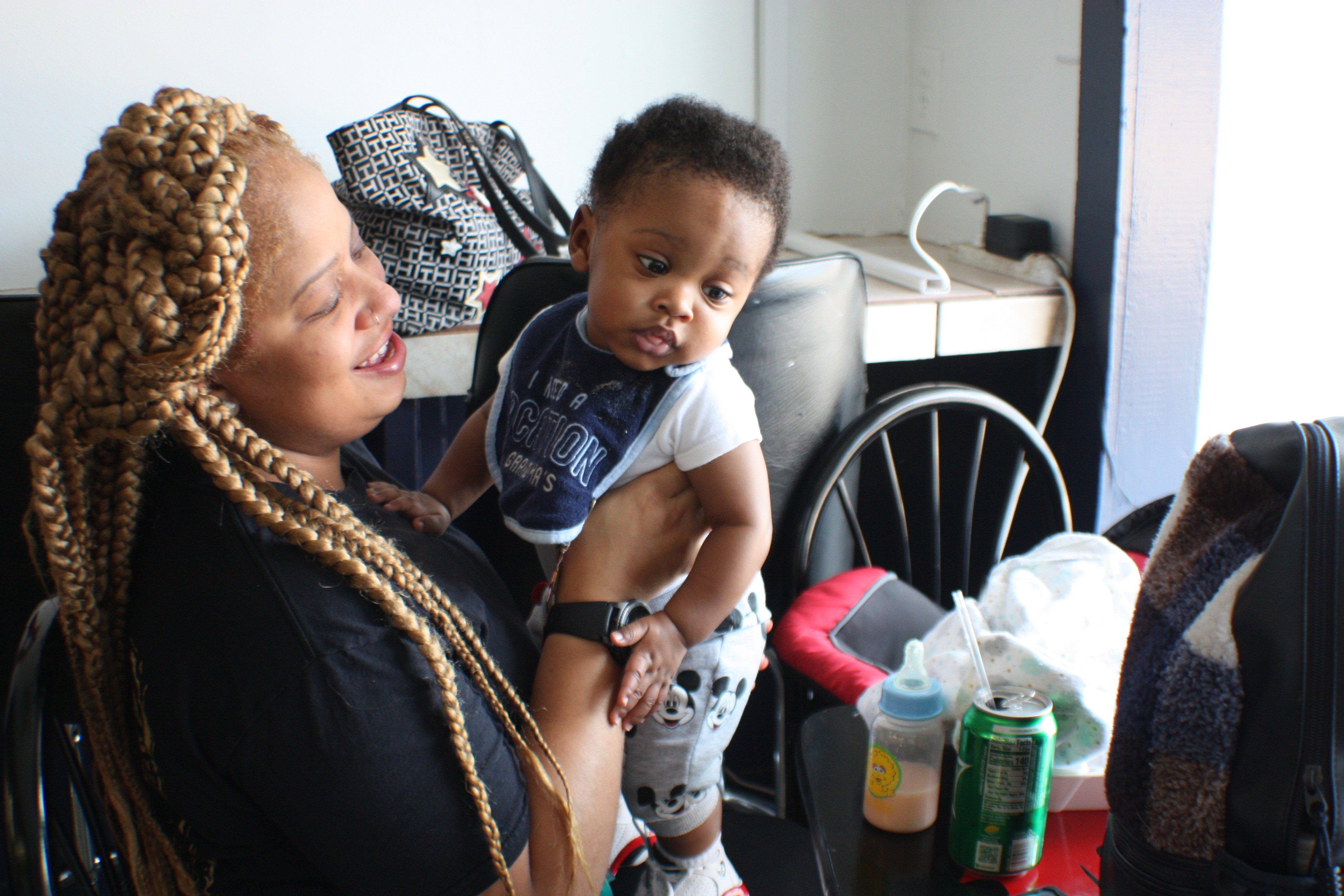 Customer Chimere Miller plays with her son J'iris after enjoying lunch at Riko's Kickin Chicken located at 1329 Madison Avenue in Madison Heights. (Cole Bradley)