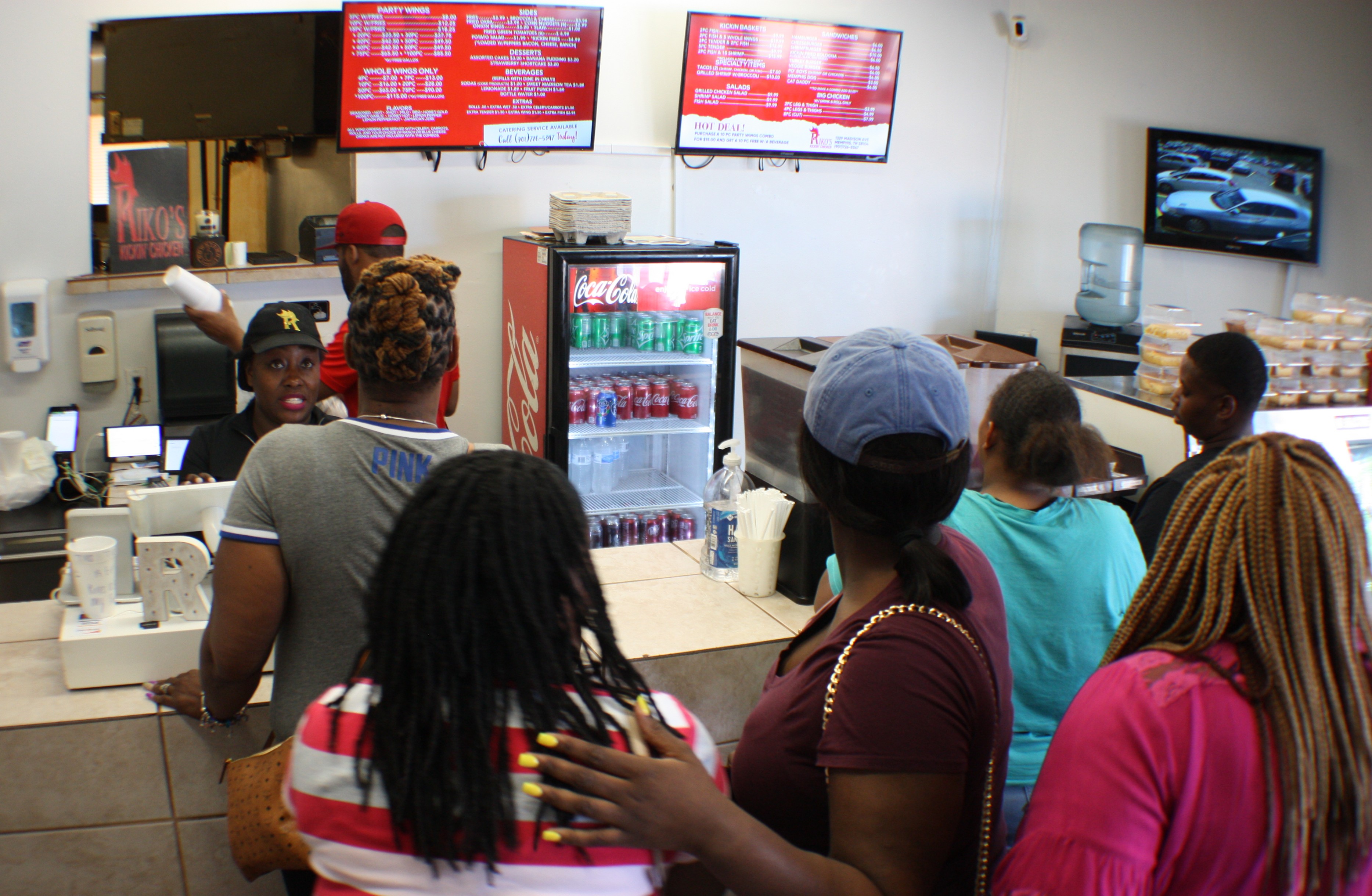 Tiffany Wiley serves a line of hungry customers. Wiley co-owns Riko's Kickin Chicken with her husband Mariko Wiley. (Cole Bradley)