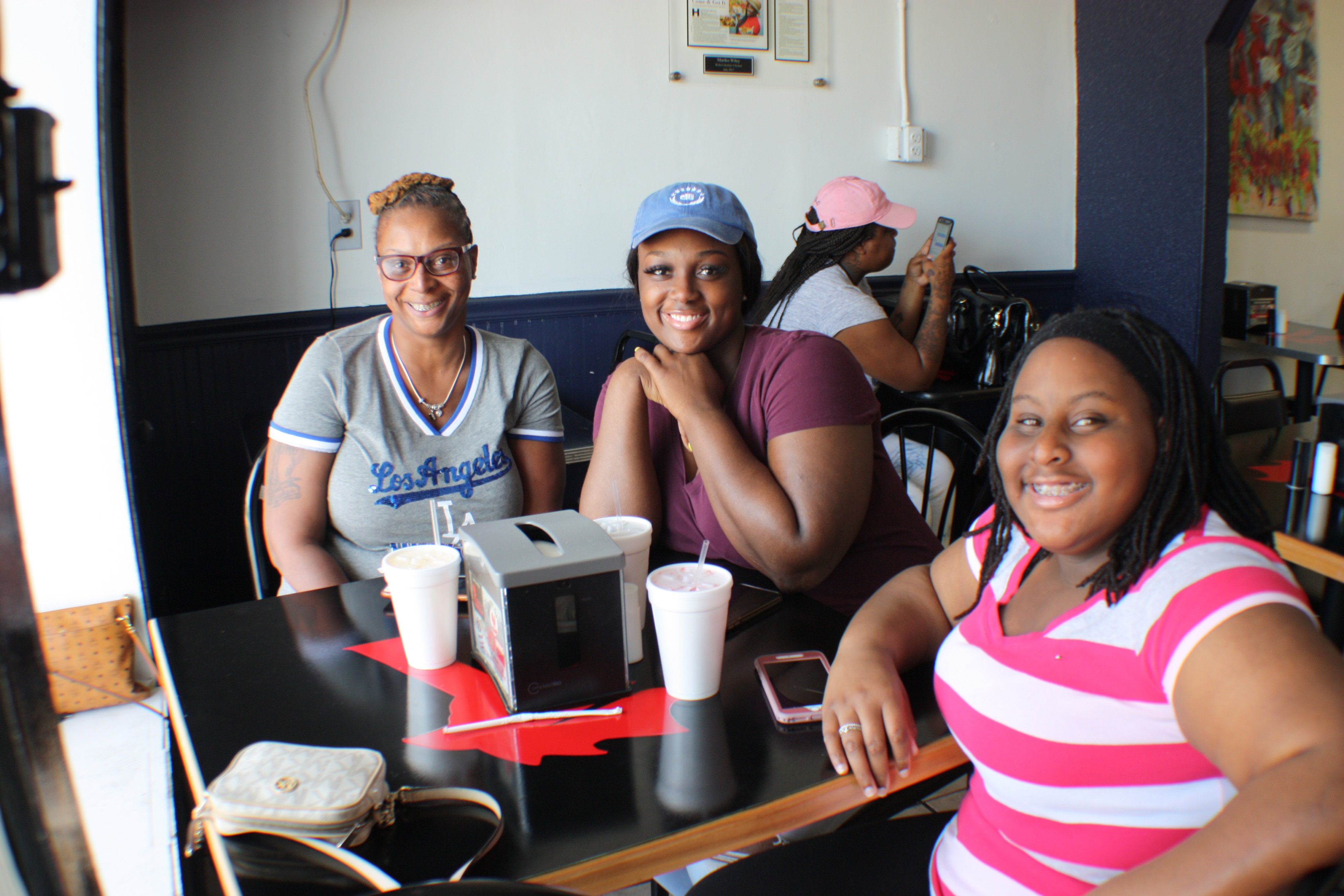 Felecia Rucker (L) brought her daughters to Riko's to try the food and says it's their new go-to spot for chicken. (Cole Bradley)