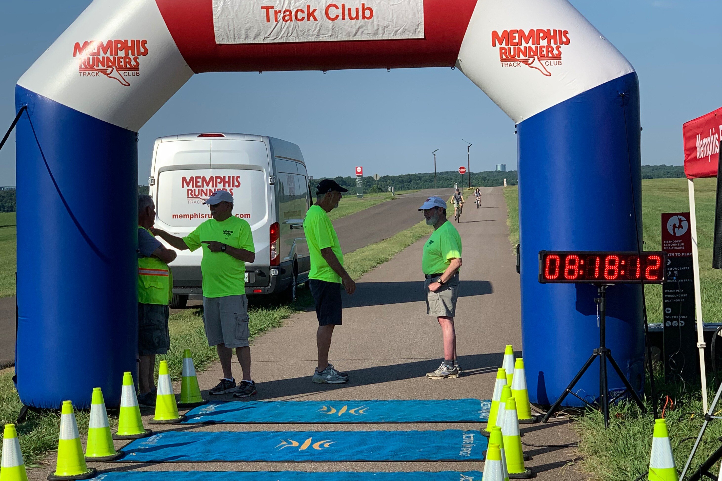 Staff and volunteers wait for participants to arrive at the finish line of the Hagar Center's first 5K fun run fundraiser. (Ashlei Williams)