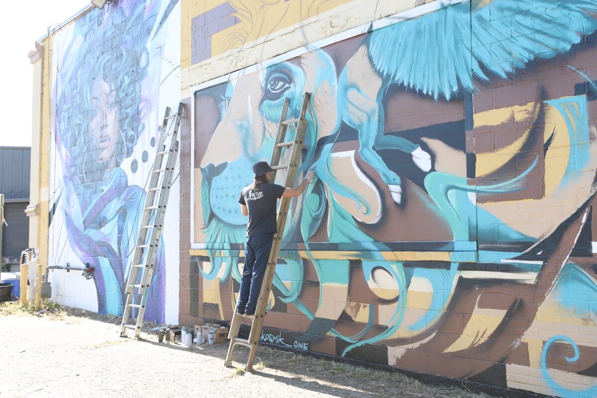 The artist known as Kosmik One at work in the Edge District.