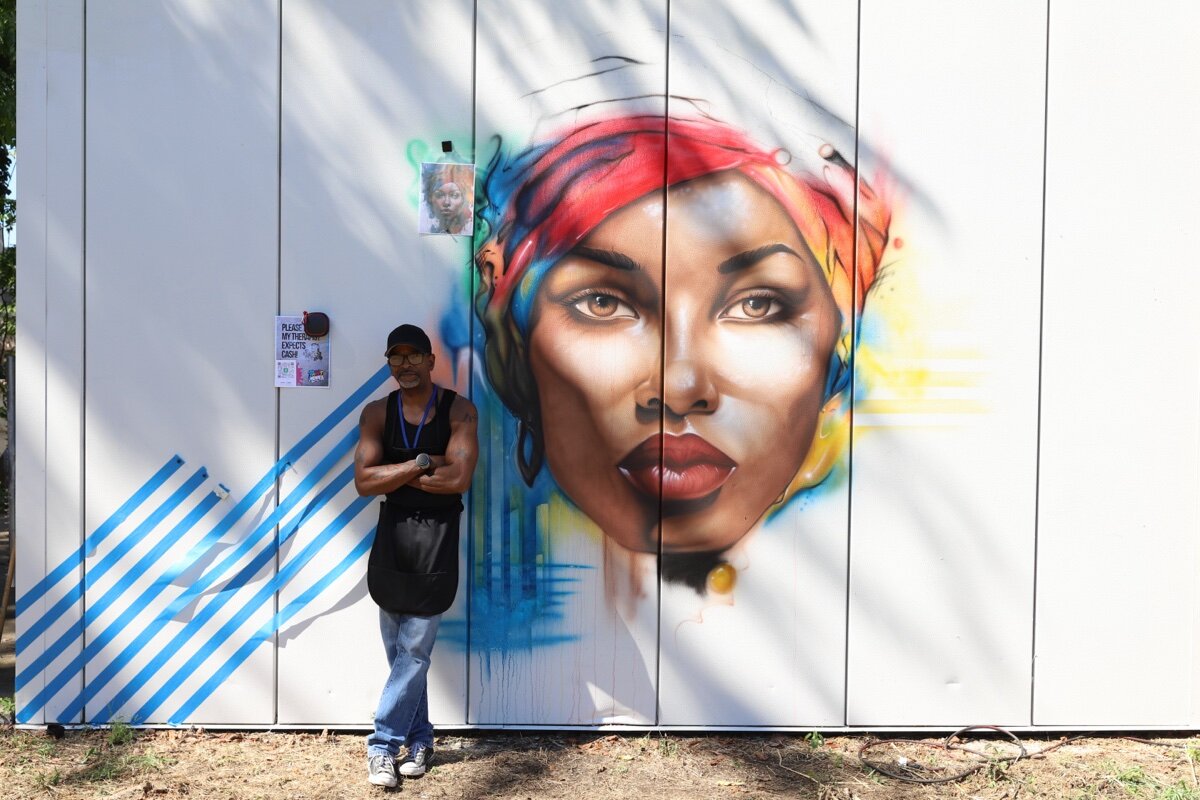 Artist Jeff Coffey stands in front of his latest work in The Edge District.