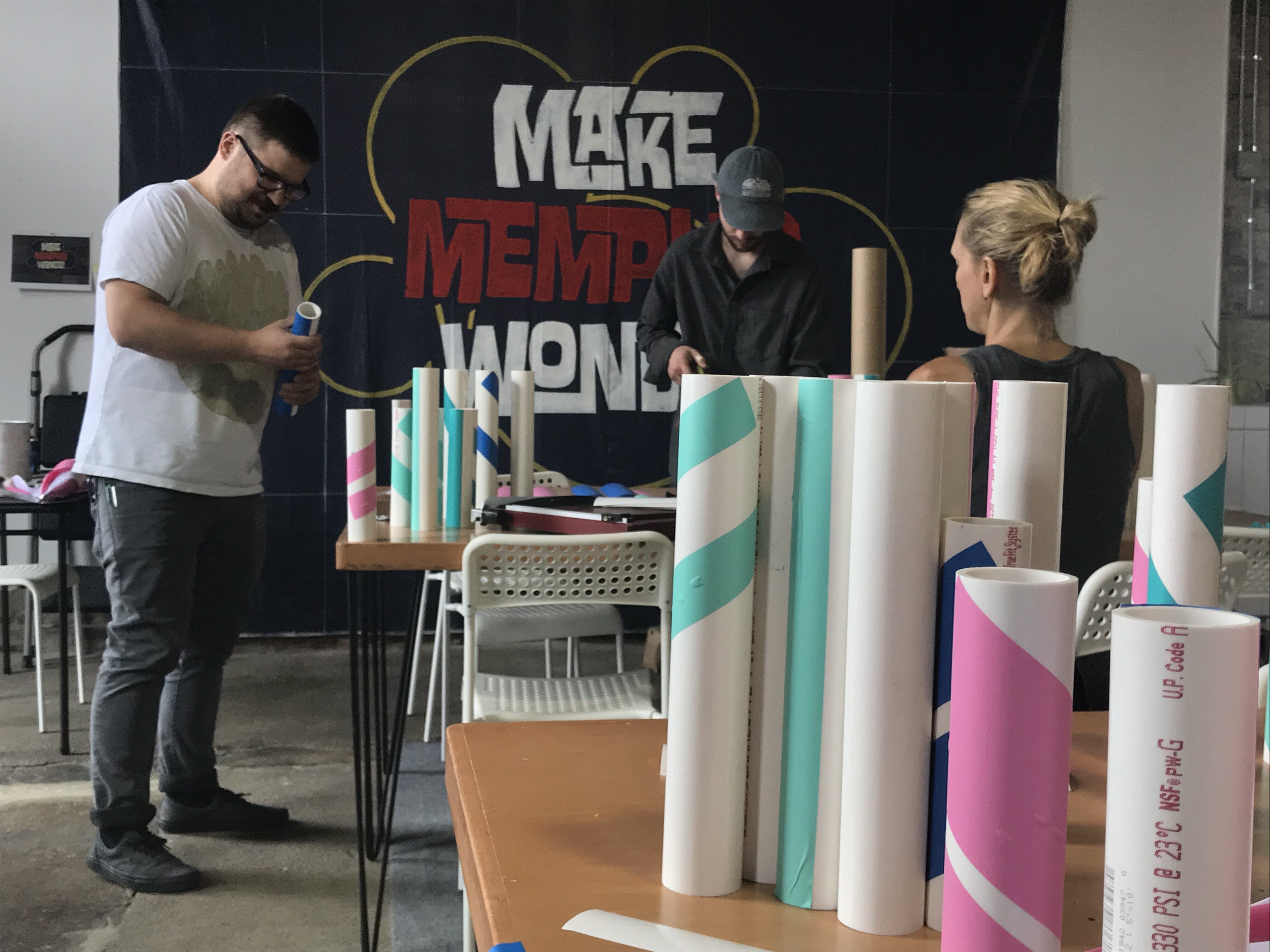 Members of the Creatives in Research team assemble tubing that will become 35 umbrella stands strategically placed throughout Madison Heights. (Wonder / Cowork / Create)
