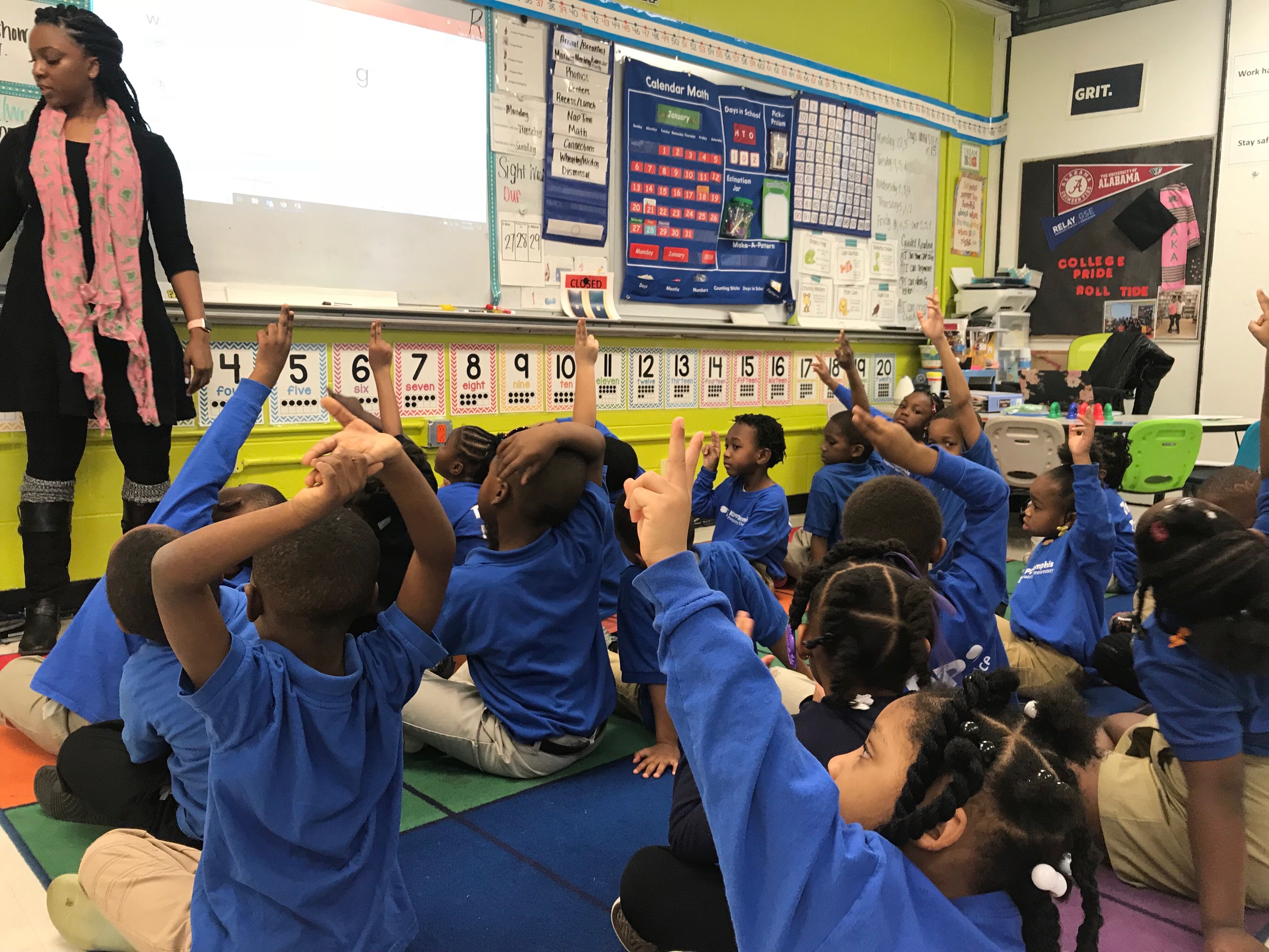 At KIPP Memphis Preparatory Elementary, teacher Nova Moss leads kindergarten students through foundational words and sounds. They use their fingers to spell the words in the air. (Cole Bradley)