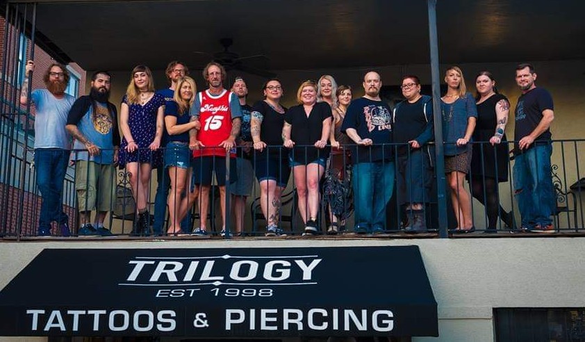 The staff stands on the balcony of Trilogy Tattoos and Piercing. Owner Richie Jarvis stands left of center in the red #15 jersey. (Submitted)