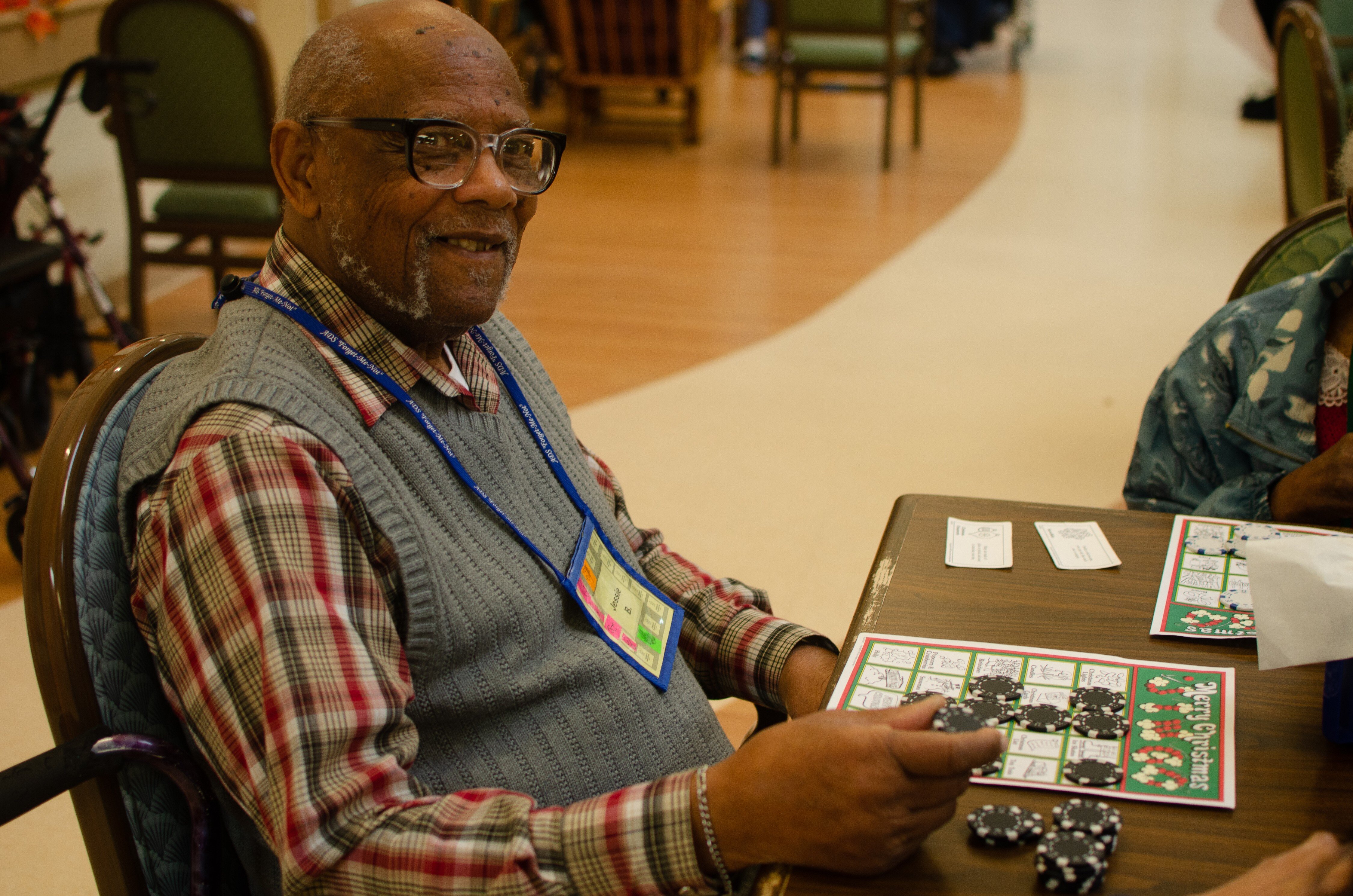 Jessie plays a Christmas-themed BINGO-style game at Dorothy's Place. Dorothy's Place offers a host of activities for Alzheimer's and dementia patients like Jessie. (Cat Evans)