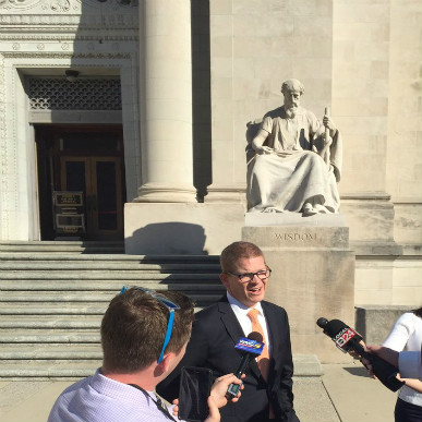 Josh Spickler announces Just City's lawsuit against Shelby County Sheriff Bill Oldham at the steps of the courthouse. 