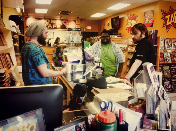 Zach Bicknell behind the counter at Jupiter Comics.