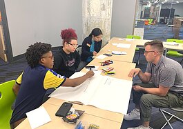 Members of the LITE Memphis Finalist Program (left) work on their business plan with the help of a volunteer (right). (LITE Memphis)