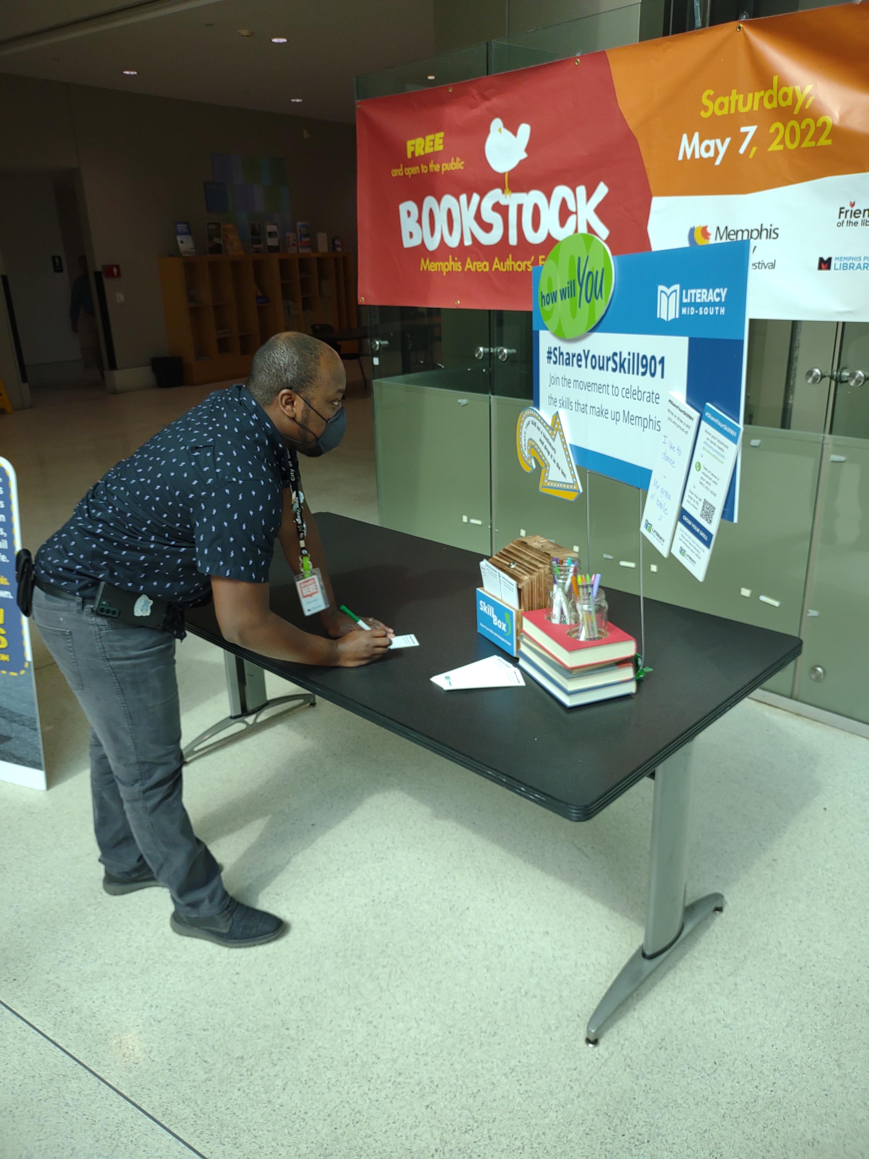 Darnell McCurdy, an employee at the Benjamin L. Hooks Library, writes his skills on a bookmark. (Photo courtesy of Literacy Mid-South)