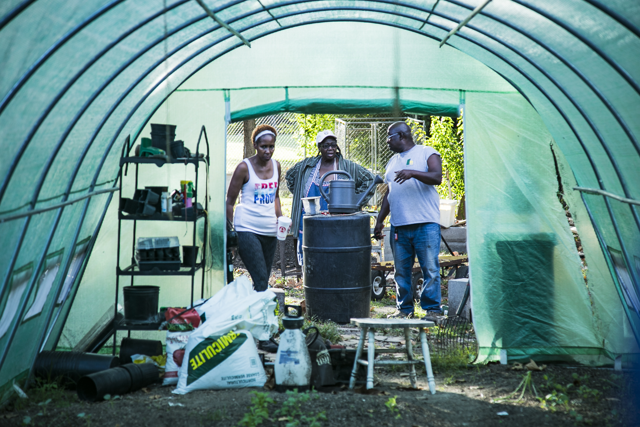 Dana Merriweather (L), Judy Conway (Center), Sidney Johnson discuss plans for the greenhouse located next to Johnson’s property on Gracewood St. (Natalie Eddings) 