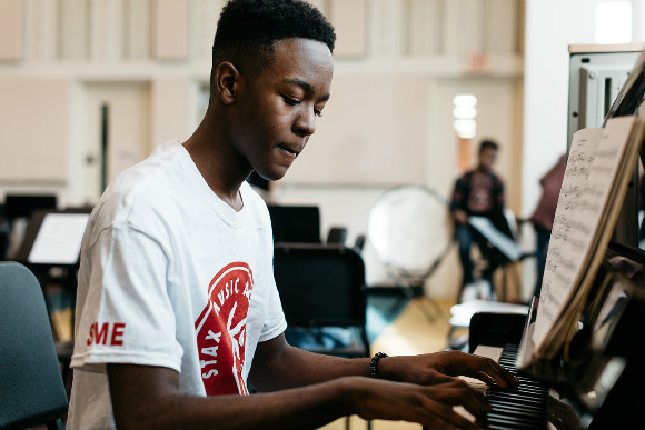 Sidney Robinson plays piano at the Stax Music Academy, a local organization supported by the National Endowment for the Arts.