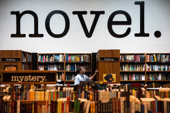Employee Scott Graves shelves books at Novel bookstore in East Memphis. (Brandon Dill/High Ground News)