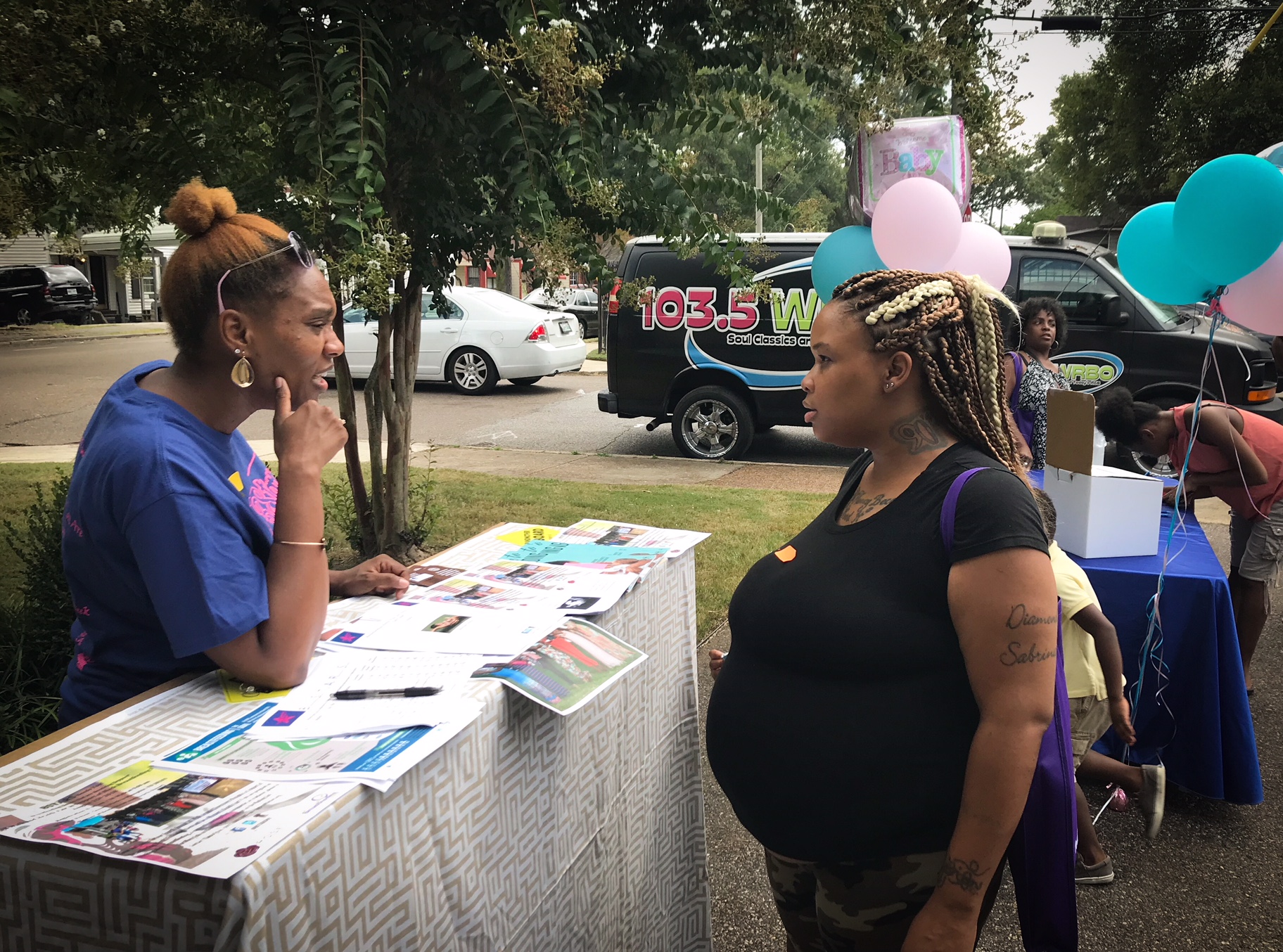 Shukura Umi with BSTARS consults with an expectant mom on workplace protections for breastfeeding. (Cole Bradley) 