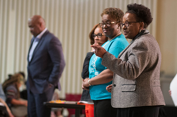 Johnny Moore, far left, CEO of SunTrust Bank, and Linda William, far right, CEO & President of the RISE Foundation, speak to students at Melrose High School about personal finances.