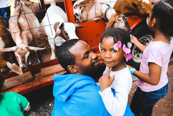 Xadion Woods brings his daughter, Taylor, to the Pre-K and Kindergarten Kickoff at the Board of Education on Saturday, May 5th. Woods is attempting to enroll his daughter in kindergarten this upcoming year. (Kirstin Cheers)