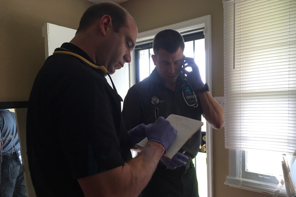 Dr. Steven Euler, right, sets up an appointment with a caller's primary care doctor for further care.