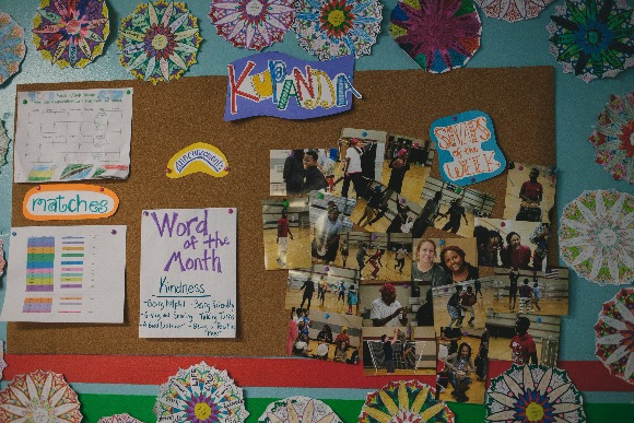 Friendly faces light up the walls of the Refugee Empowerment Program facility. (Averell Mondie)