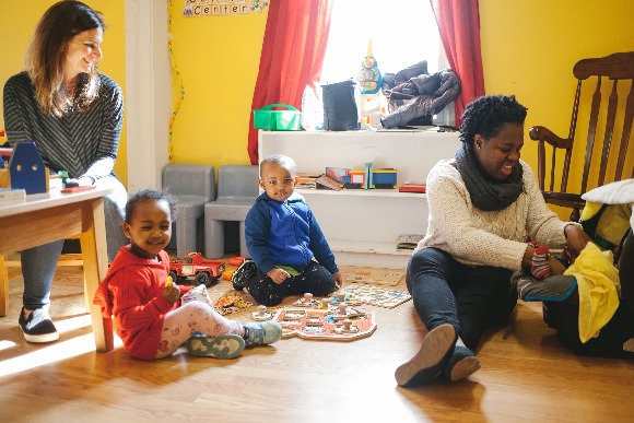 Refugee Empowerment Program volunteers and children in the facility's nursery. (Averell Mondie)