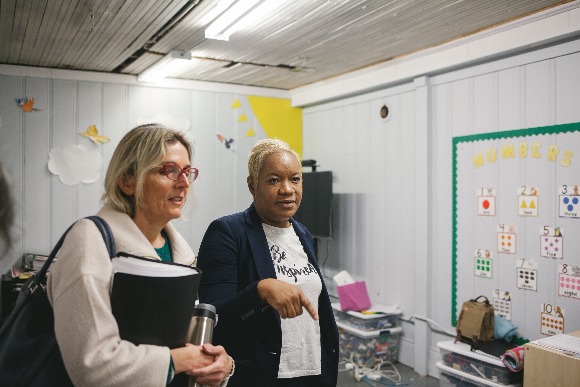 Katy Spurlock, program director with Urban Child Institute (L) and Refugee Empowerment Program director Camela Echols (R) tour the Binghampton facility. (Averell Mondie)