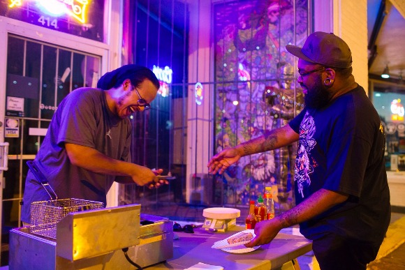 Rico Fields serves a line of hungry concert-goers during Soul Roll Saturdays at the Hi-Tone Cafe. 