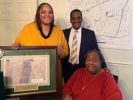 L to R: Shelby County Commissioner Tami Sawyer, Commissioner Eddie Jones, and Quincey Morris, executive director of the Klondike Smokey City CDC pose with a map of the 150 parcels transferred from the land bank to the CDC and NPI. (Ashlei Williams)