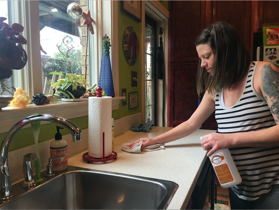 Owner Carla Worth cleans a client's house using her homemade products.