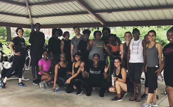 A class poses for a post-workout victory photo at a Spincult free public spin event held at Health Sciences Park in the Medical District. (Spincult)