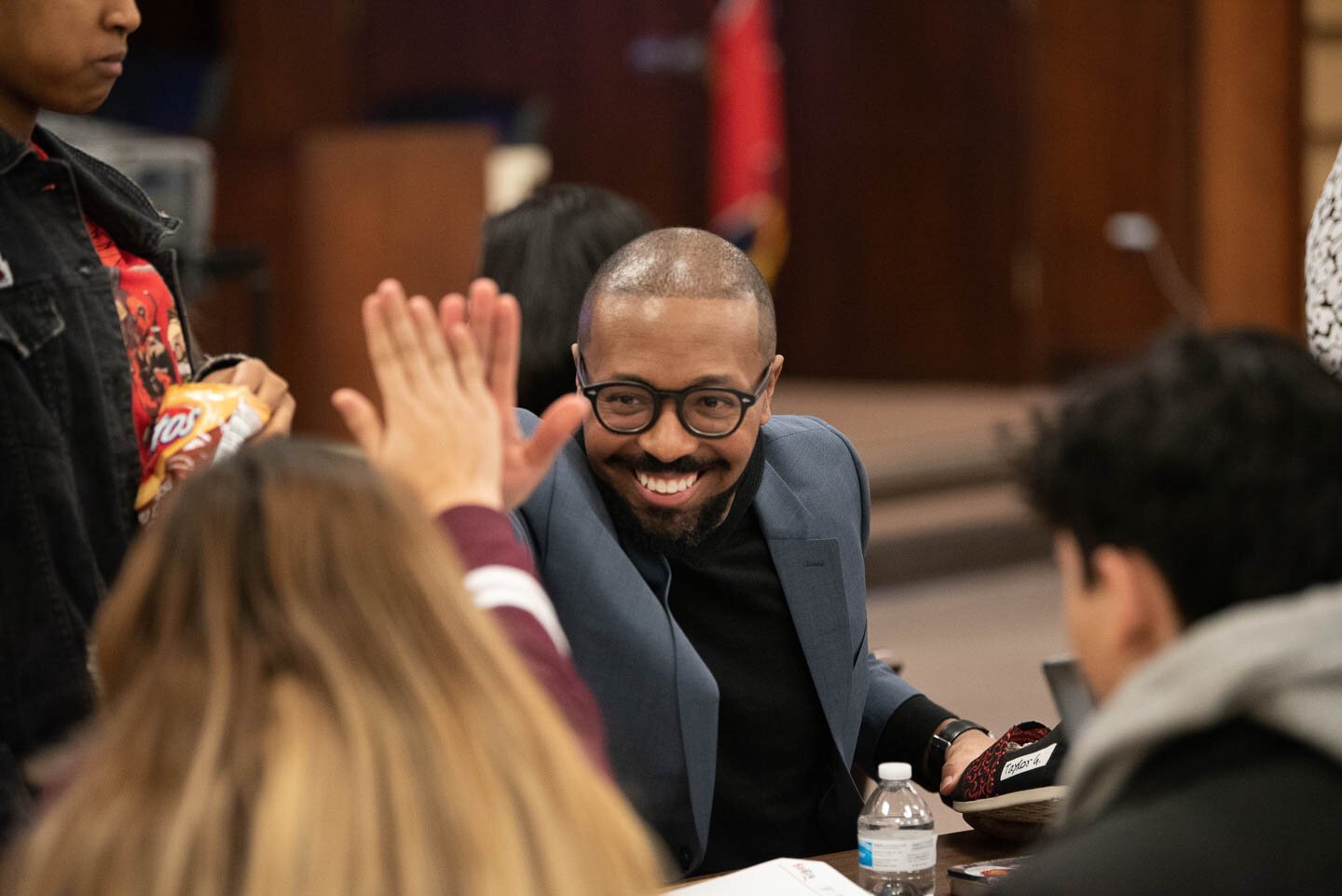 Edward Bogard, founder of Memphis-based nonprofit shoe manufacturer SoGiv, high fives a student at the three-day teen design charrette benefiting Shelby County Schools. (Demarcus Bowser)