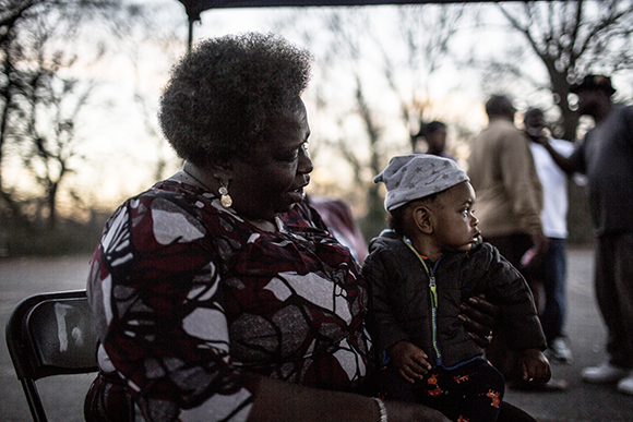  Rita sits with her friend’s baby Honeybun while at a cookout near the old Firestone plant. 