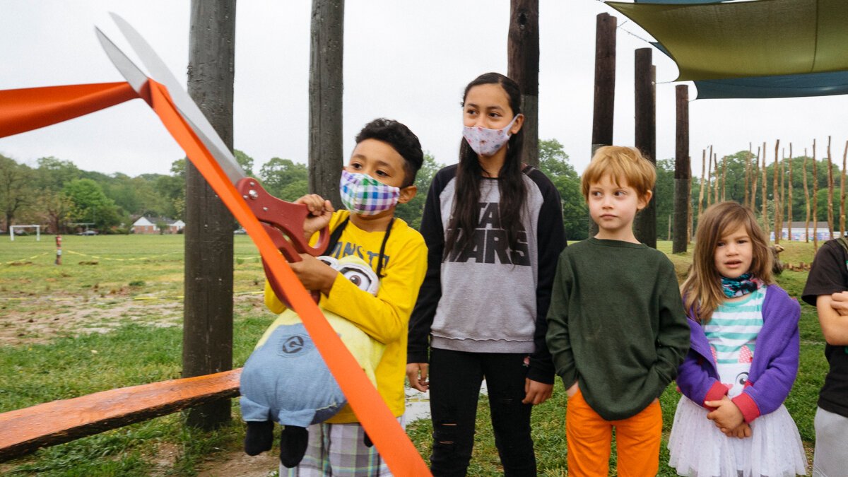 Treadwell Elementary student Andres Arevalo cuts the ribbon for the new Treadwell Park nature playground. (Ziggy Mack)