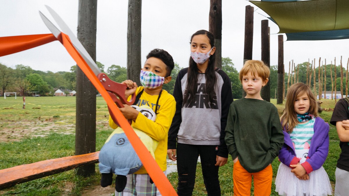 Treadwell Elementary student Andres Arevalo cuts the ribbon for the new Treadwell Park nature playground. (Ziggy Mack)