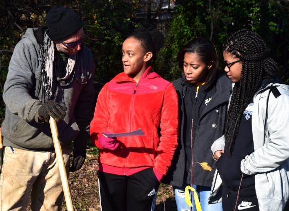 Mike Larrivee works with students from the Bridge Builders program at a December 9 planting event.