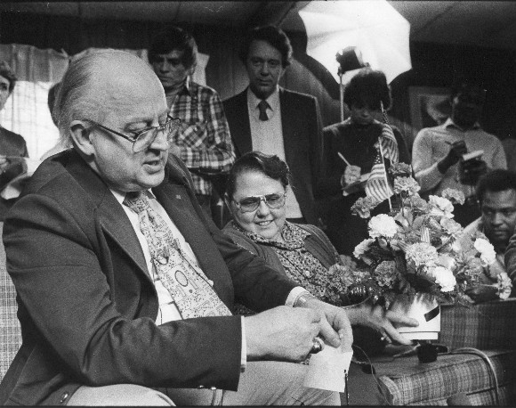 Dr. Ernest and Susan Cooke receive flowers from well wishers upon the release of their son from Iran