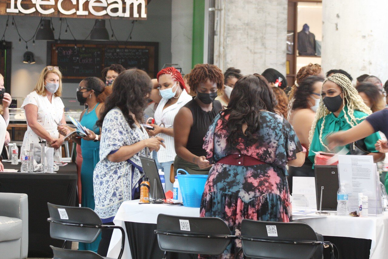 Attendees of the WBC South grand opening networked with each other and several women-owned businesses tabling the event, including New York Life Insurance Company (foreground) and LEO Events (background, left) (HGN / Cole Bradley)