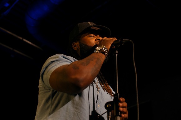 A local artist sings to the crowd at The Den during the weekly Monday night event, The Word where creatives in Memphis gather to exchanges poems, song, jokes, and stories. 